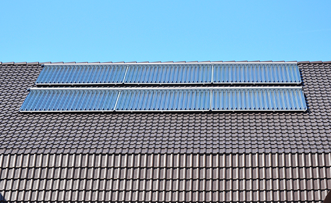 glazed solar collectors on roof above pool